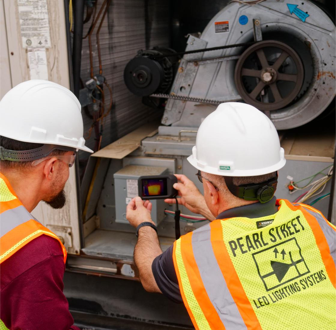Pearl Street employees inspecting heat on a system